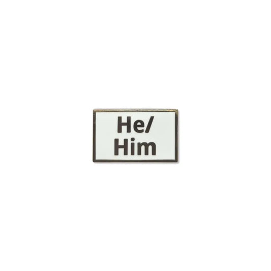 Rectangular He/Him lapel pin with a clean white enamel background and bold black lettering, framed with a thin metallic border a clear and simple pronoun badge ideal for everyday wear.