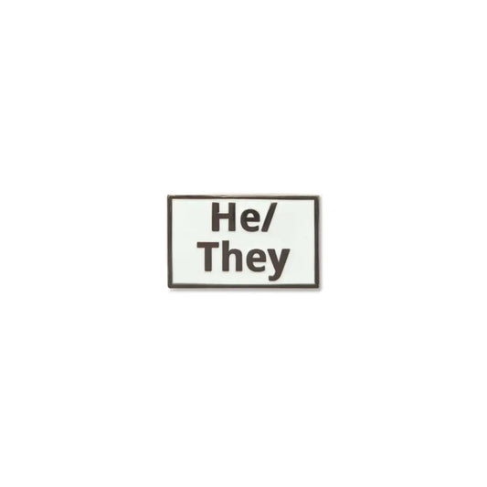 Rectangular He/They lapel pin with a white enamel background and bold black lettering, outlined by a slim metallic border a clear and modern pronoun pin for gender expression.