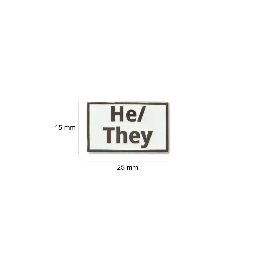 Compact He/They lapel pin in black with silver-tone embossed text, displayed with a size of 25mm by 15mm a stylish and inclusive accessory for everyday wear.