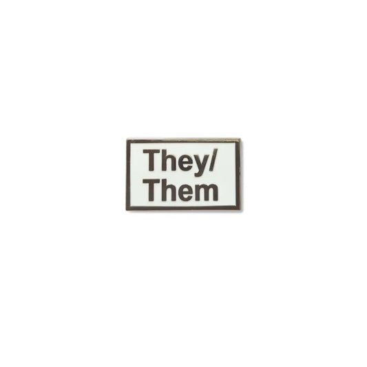 Rectangular They/Them lapel pin featuring a white enamel background with bold black text and a thin metallic border a clear and stylish pronoun badge for gender-neutral expression.