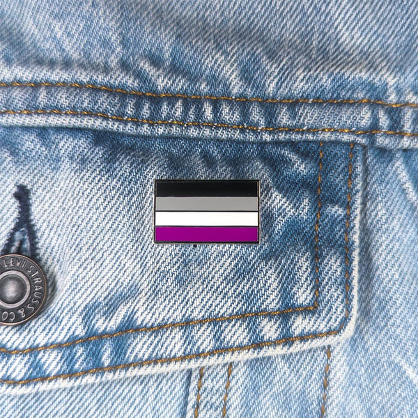 Close up image of an asexual pin on a denim jacket pocket