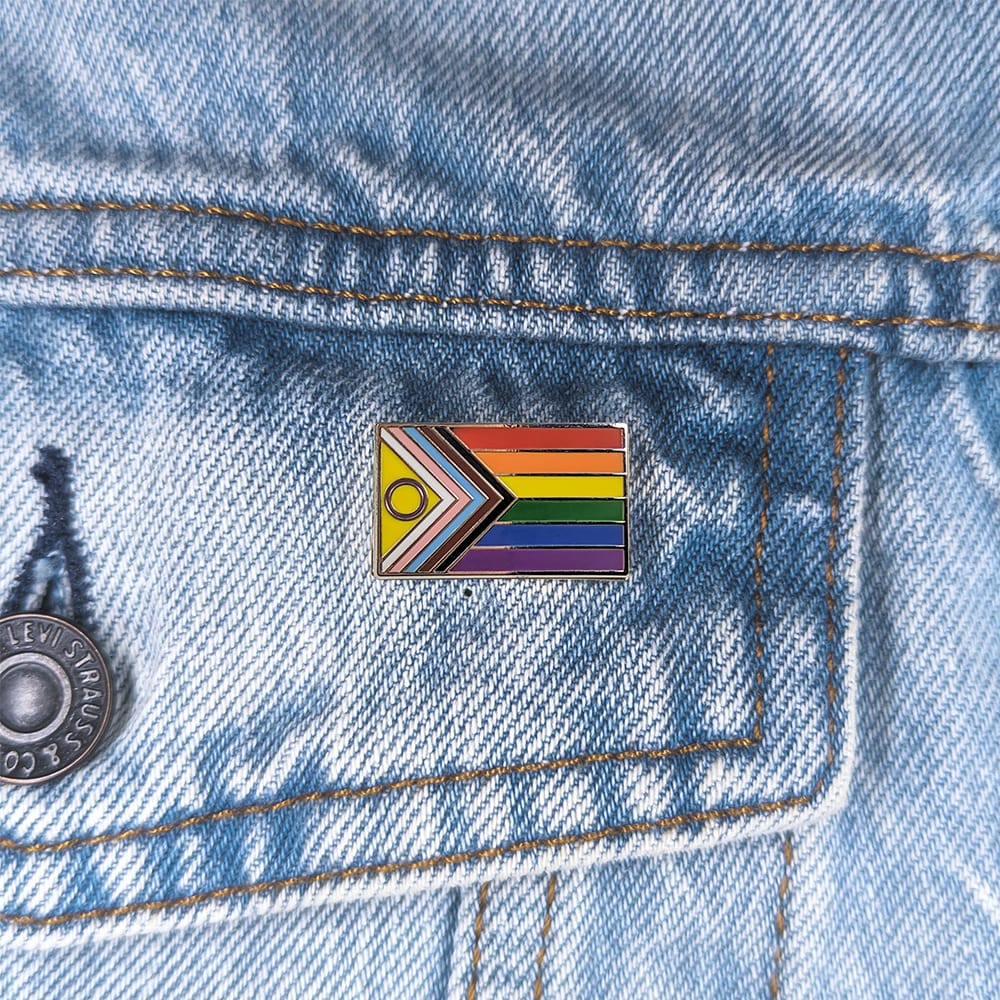 An image of a Intersex Inclusive Pride pin on a denim jacket pocket