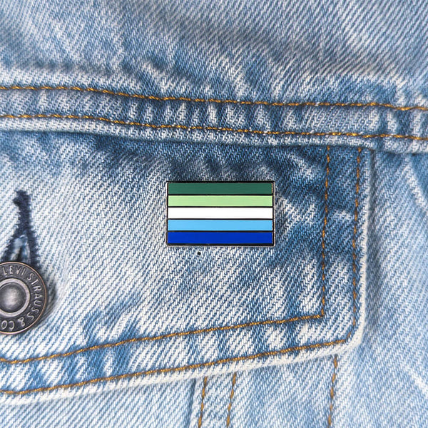 An image of a MLM pin on a denim jacket pocket