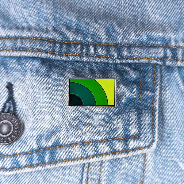An image of a mental health pin on a denim jacket pocket