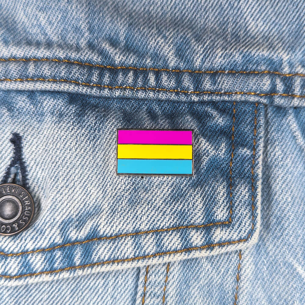 An image of a pansexual pin on a denim jacket pocket
