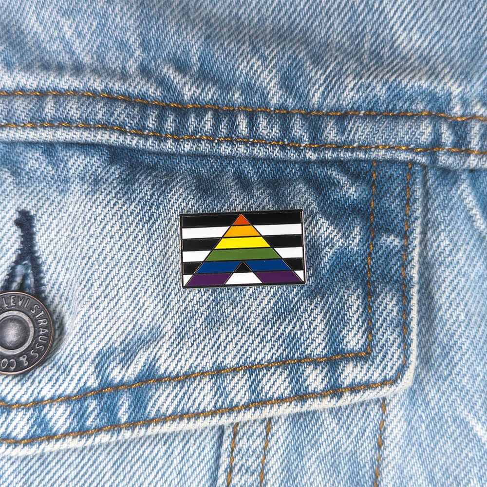 An image of a straight ally pin on a denim jacket pocket