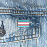 An image of a transgender pin on a denim jacket pocket