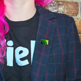 A mental health pin on the lapel of a woman